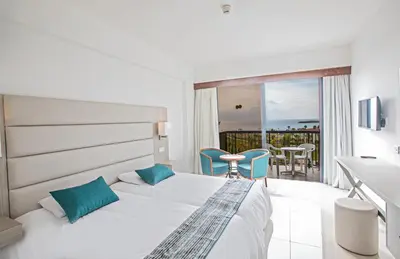 a hotel room with a bed and a balcony at Nelia Sea Breeze in Ayia Napa