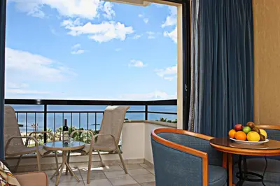a room with a balcony with a view of the ocean at Anastasia Waterpark Beach Resort in Protaras