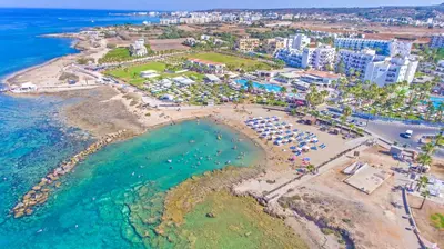 an aerial view of a beach and the ocean at Anastasia Waterpark Beach Resort in Protaras