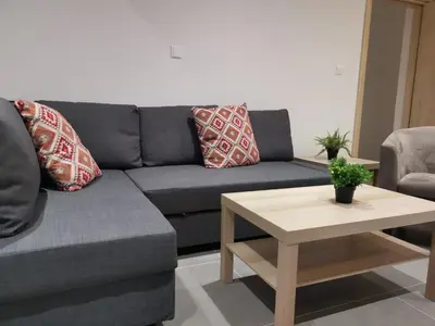 a living room with a couch and a coffee table at Martins 3 Bedroom Flat in Larnaka