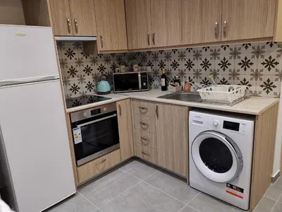 a kitchen with a refrigerator and a washing machine at Martins 3 Bedroom Flat in Larnaka