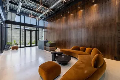 a lobby with couches and a table and some windows at Rooftop Sunset Garden by Staycom in Pamboula