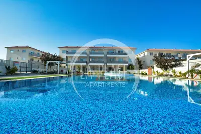 a large swimming pool in front of a building at Cosy 2Br Family Apartment - Mythical Sands Resort in Paralimni