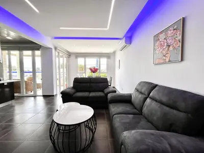 a living room with a couch and a table at STAY NEO Coast Apartment in Limassol