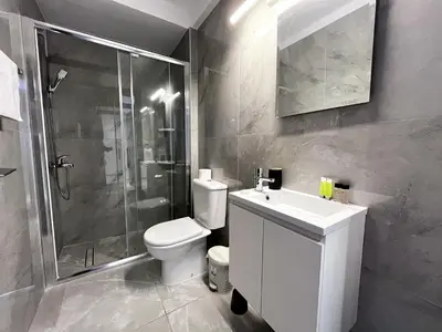 a bathroom with a toilet and a shower and a sink at STAY NEO Coast Apartment in Limassol