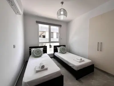 a room with two beds and a window at STAY NEO Coast Apartment in Limassol