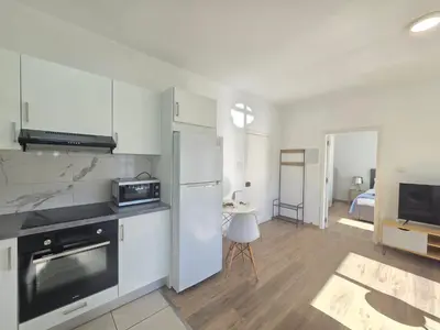 a kitchen with a refrigerator and a microwave at 1 bd at Mediterranean Beach - Limassol Bay B206 in Limassol