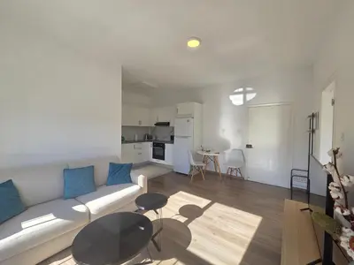 a living room with a couch and a table at 1 bd at Mediterranean Beach - Limassol Bay B206 in Limassol