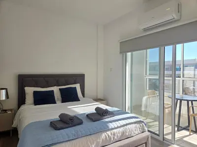 a bedroom with a bed with two towels on it at 1 bd at Mediterranean Beach - Limassol Bay B206 in Limassol