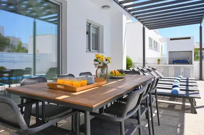 a wooden table with a tray of oranges on a patio at Villa Brigita in Ayia Napa