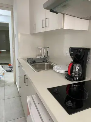 a kitchen with a sink and a coffee maker on a counter at Mangoes & Cherries in Ayia Napa