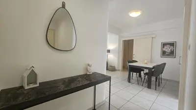 a bathroom with a table and a mirror on the wall at STAY Elion Apartment in Nicosia