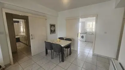 a kitchen and dining room with a table and chairs at STAY Elion Apartment in Nicosia