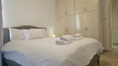 a bedroom with a white bed with towels on it at STAY Elion Apartment in Nicosia