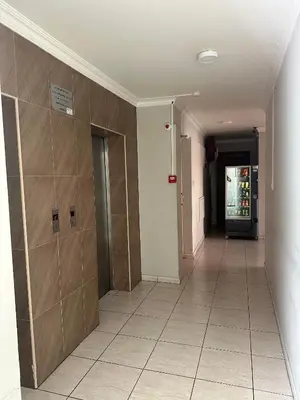 a hallway with a door and a tile floor at Ellis Hotel Apartments in Larnaka