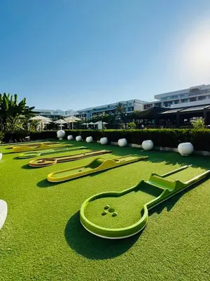 a group of green clocks on a field of grass at Wakacyjny apartament w Courtyard Long Beach Holiday Resort in Iskele