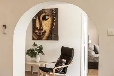 a room with a chair and a painting of a mask at Galata Watermill Cottage in Nicosia