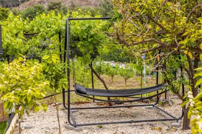 a hammock in the middle of a garden at Galata Watermill Cottage in Nicosia