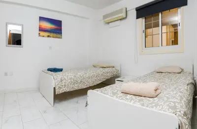 a room with two beds and a window at Martin 2 bed Apartment in Larnaka
