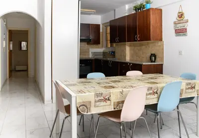 a kitchen with a dining table and chairs at Martin 2 bed Apartment in Larnaka