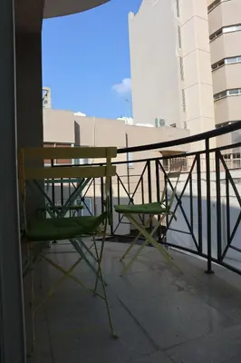 a table and two chairs sitting on a balcony at Martin 2 bed Apartment in Larnaka