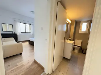 a living room with a couch and a toilet in a room at Stasandrou City Center Residence in Nicosia
