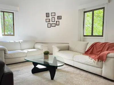 a living room with a white couch and a table at Stasandrou City Center Residence in Nicosia