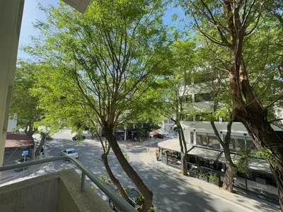 a view of a street with trees and a building at Stasandrou City Center Residence in Nicosia