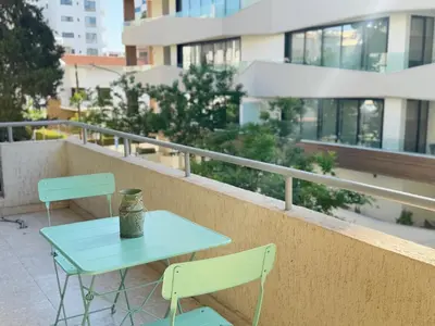 a table and chairs on the balcony of a building at Stasandrou City Center Residence in Nicosia