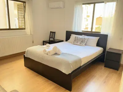 a bedroom with a bed with two towels on it at Stasandrou City Center Residence in Nicosia