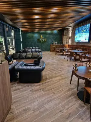 a restaurant with leather couches and tables and chairs at Grand Sapphire Resort & Casino in Phikardhou