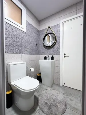 a bathroom with a white toilet and a mirror at Nomad's Nest - Quiet flat with terrace in Ayia Napa