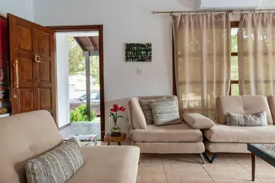 a living room with a couch and a chair at Villa Althea, Pool, Mountain Views, BBQ ,Patio in Laneia in Lania