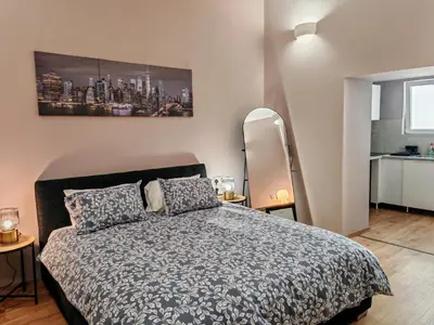 a bedroom with a bed and a painting on the wall at Studio in the center of Nicosia 3 in Nicosia
