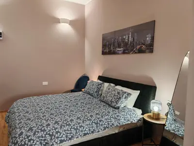 a bedroom with a bed and a painting on the wall at Studio in the center of Nicosia 3 in Nicosia