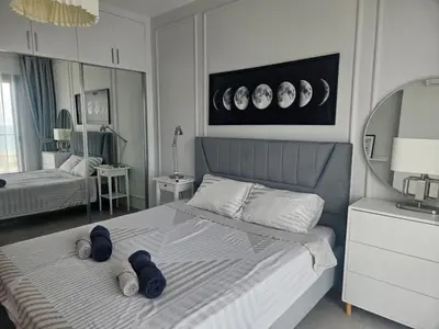 a bedroom with a bed and a mirror at Seaview Apartment at Caesar Blue Complex Northern Cyprus H68 in Dherinia