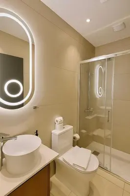 a bathroom with a toilet and a sink and a shower at NÓA Rooms - Adults Only in Ayia Napa