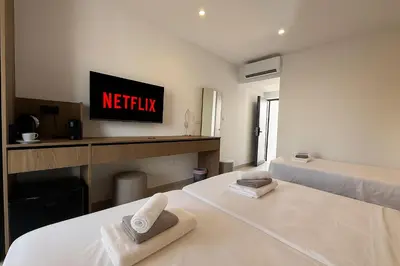 a hotel room with a bed with two towels on it at NÓA Rooms - Adults Only in Ayia Napa