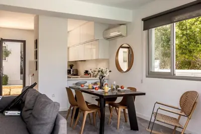 a kitchen and dining room with a table and chairs at Sam's Villa in Paralimni
