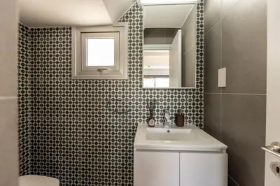 a bathroom with a sink and a mirror at Sam's Villa in Paralimni