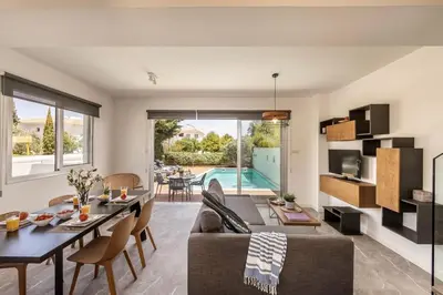 a living room with a couch and a table at Sam's Villa in Paralimni