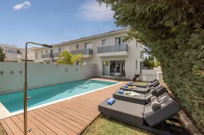 a villa with a swimming pool and a house at Sam's Villa in Paralimni