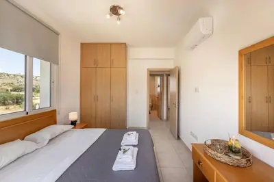 a bedroom with a large bed and a large window at Villa Parrog in Protaras