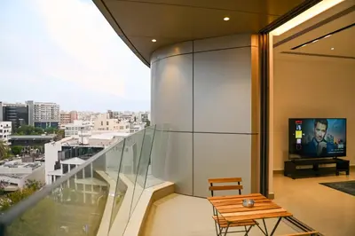 a balcony with a table and a tv on a building at The 1 -Nicosia Elite Stay- Gym Pool 24h Concierge in Nicosia
