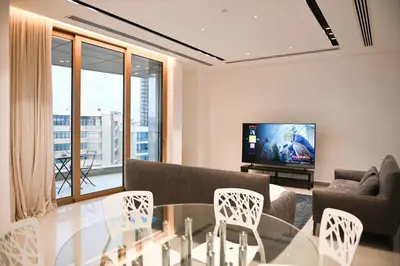 a living room with a table and a tv at The 1 -Nicosia Elite Stay- Gym Pool 24h Concierge in Nicosia