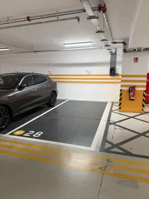 a parking garage with a car parked in it at The 1 -Nicosia Elite Stay- Gym Pool 24h Concierge in Nicosia