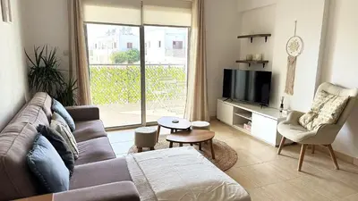 a living room with a couch and a tv at Relaxing 2BDR Retreat in Protaras in Paralimni