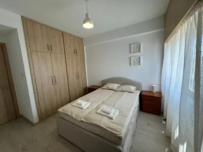 a bedroom with a bed with two pillows on it at 2 BR apartment in the Limassol with sea view in Limassol