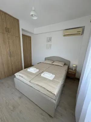 a bedroom with a bed with two towels on it at 2 BR apartment in the Limassol with sea view in Limassol