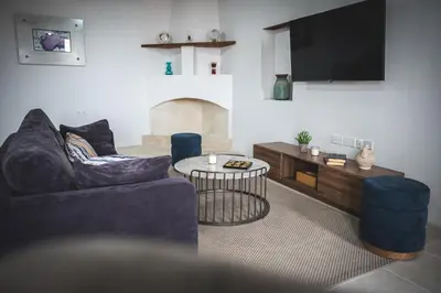 a living room with a couch and a tv at Althaea Mare in Lofou